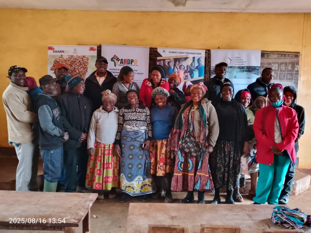 Large group photo of community members and project partners
